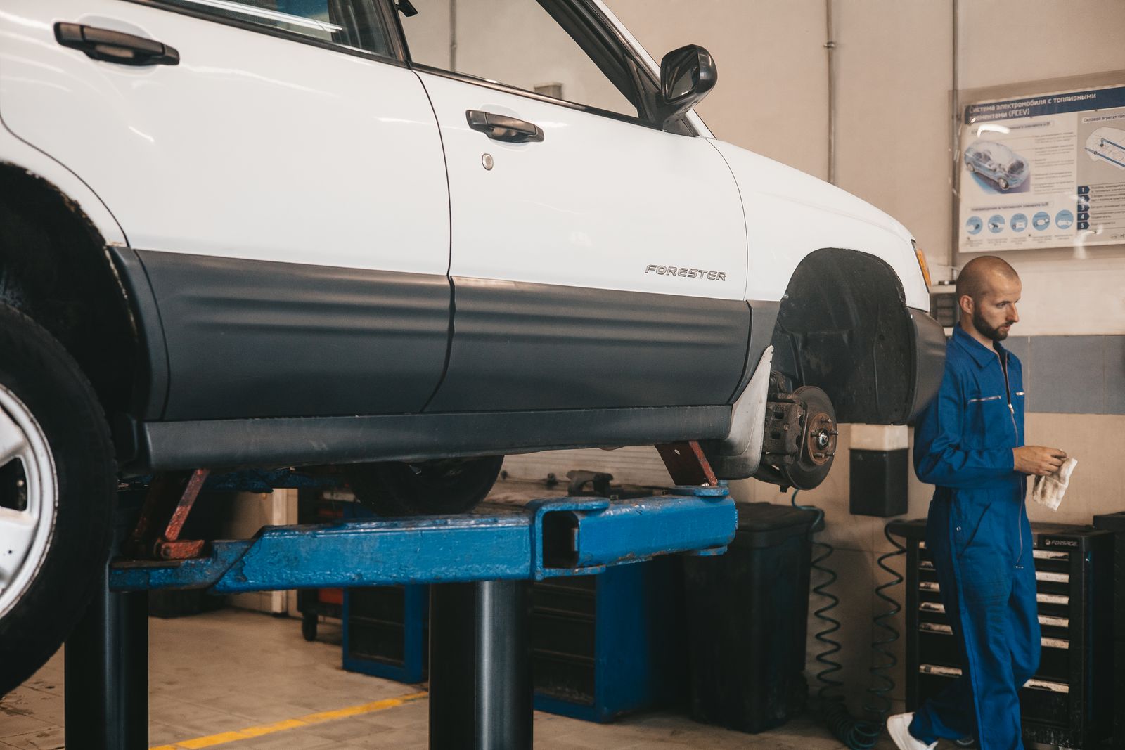 A vehicle on a lift being checked over